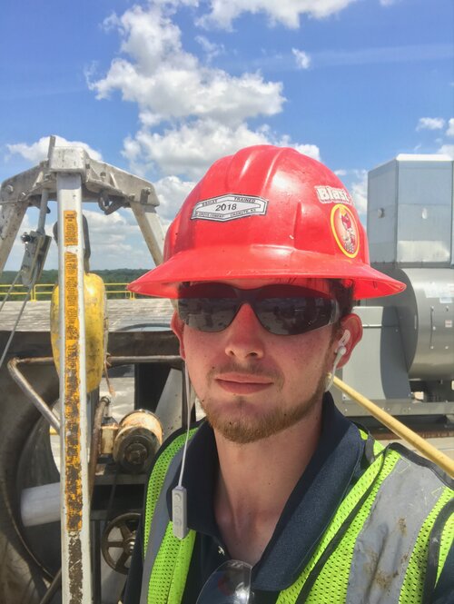 headshot of tyler construction worker with red hard hat