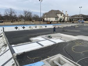 olympic sized pool being sandblasted clean