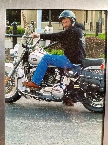 les on his motorcycle with helmet on