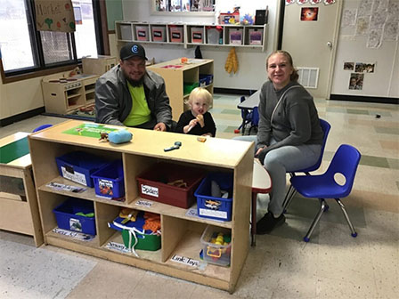 andrew with family in classroom