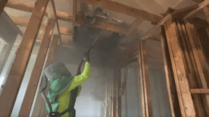 crew member sandblasting baking soda media onto damaged ceiling