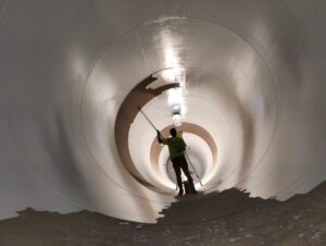 crew member coating inside of tank