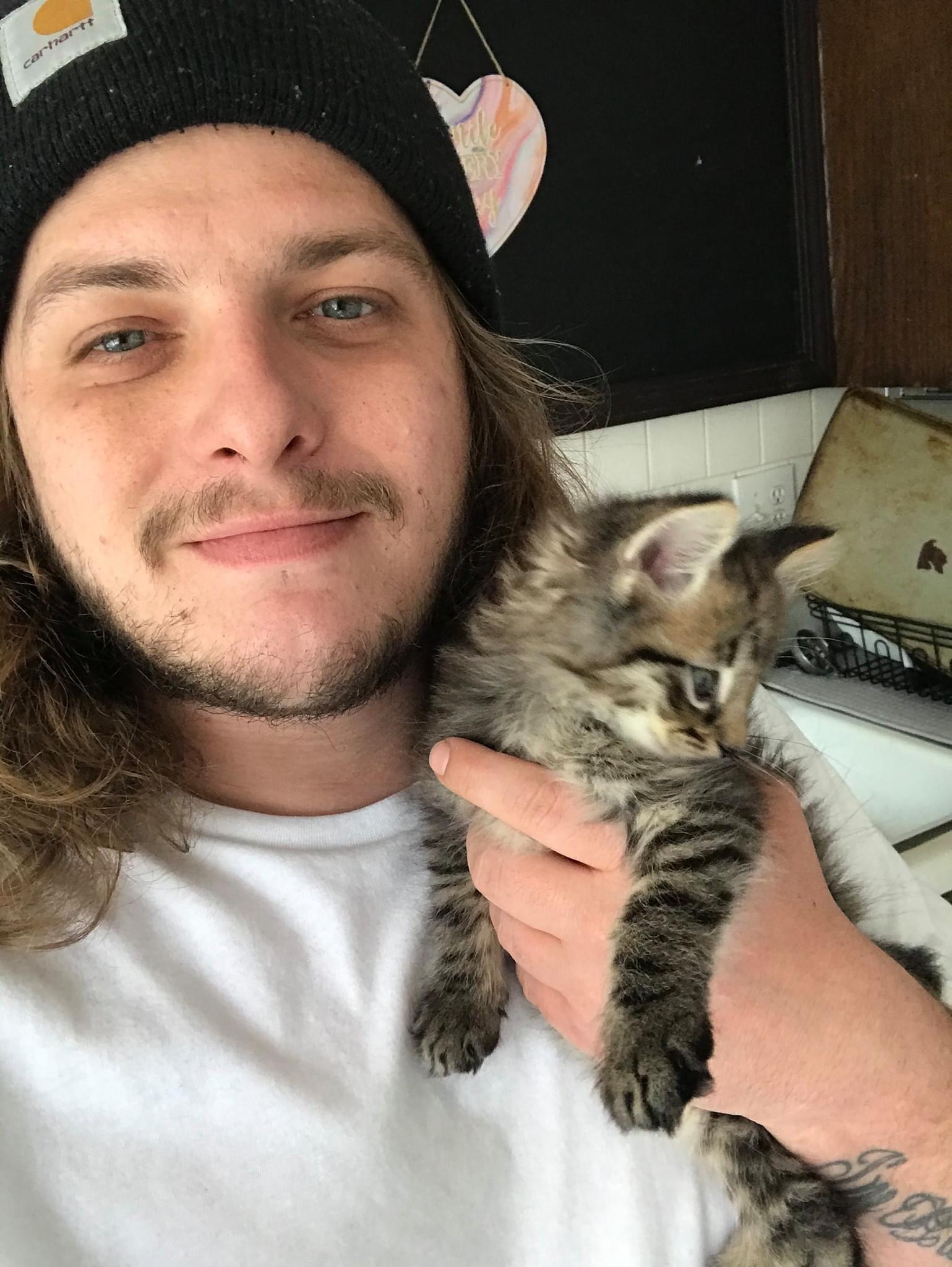 headshot of gage with his kitten