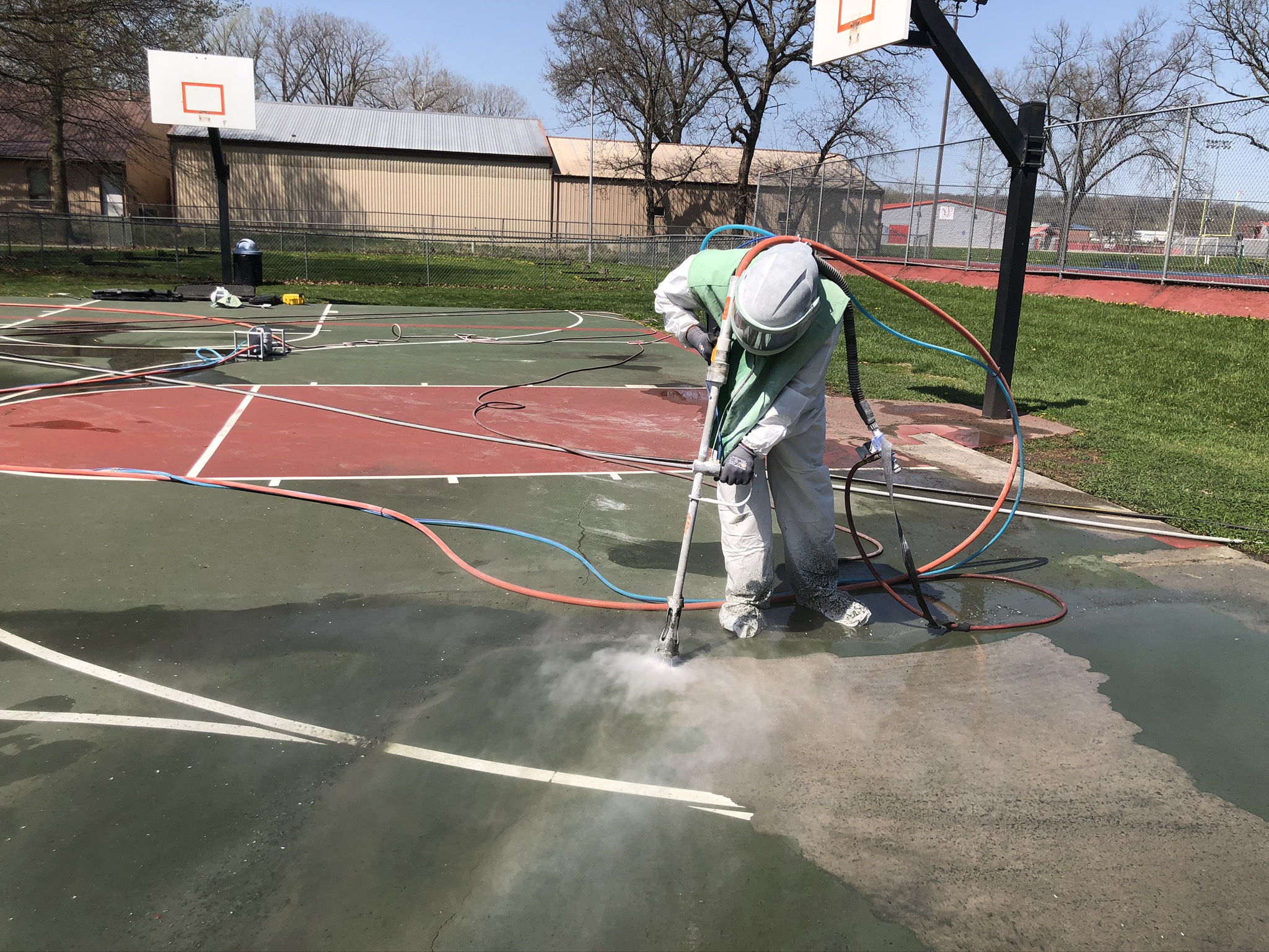 nationwide sandblasting services crew member hydro blasting basketball court