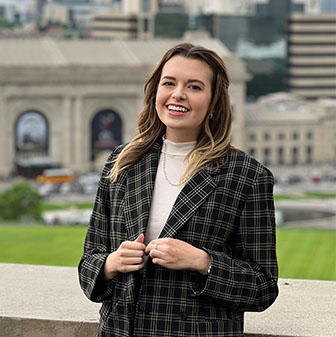 Headshot of Blast It Clean's Marketing Specialist, Sarah in front of downtown kansas city