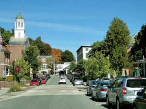 street in downtown city area in new hampshire with parked cars