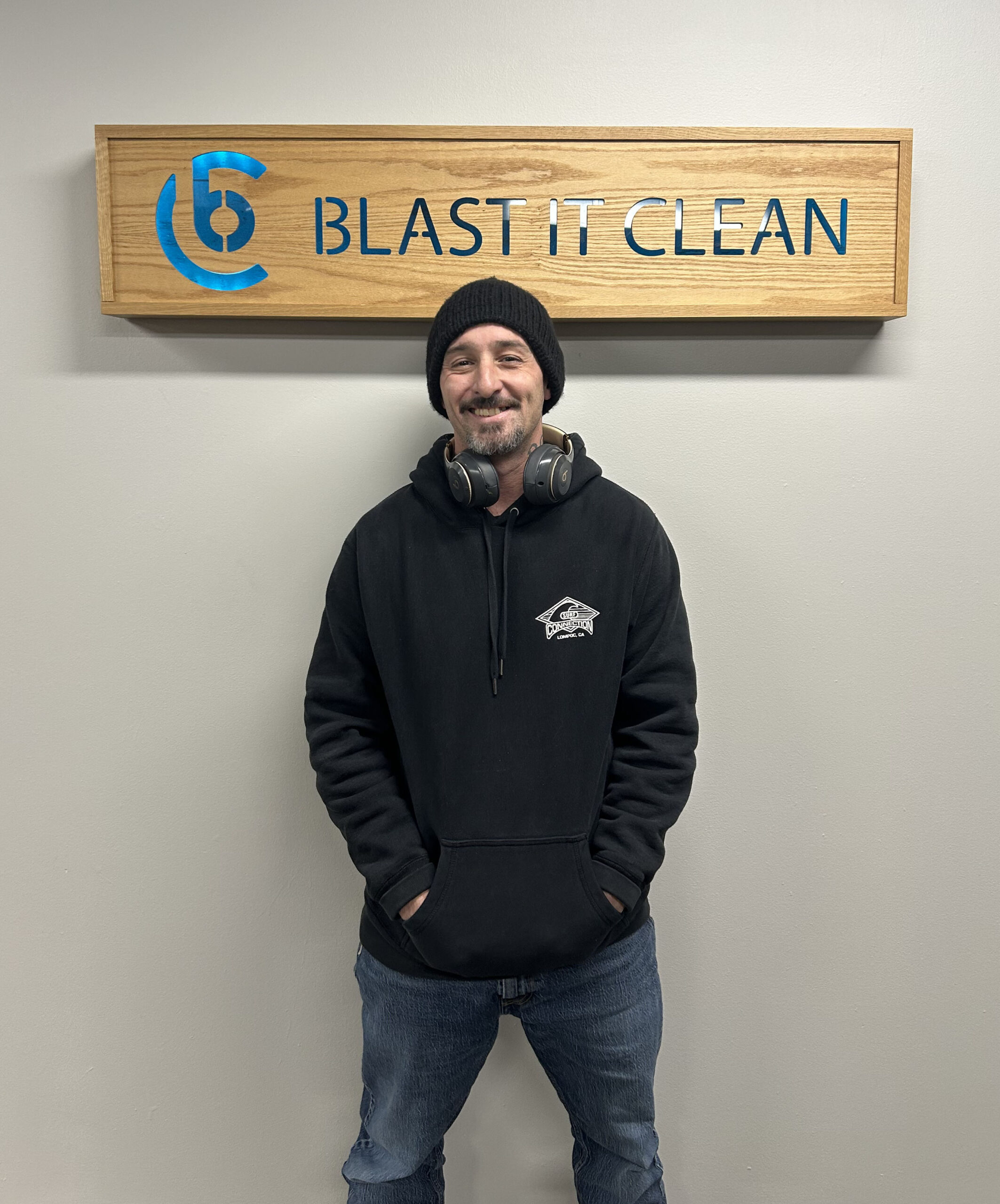 portrait of daryl in front of blast it clean logo sign