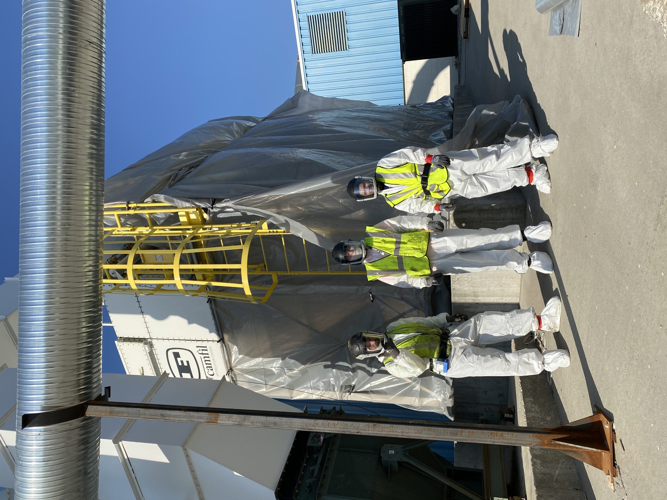 construction workers in full PPE for routine baghouse cleaning