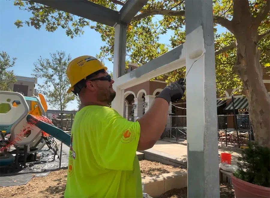 construction worker painting steel beams construction worker painting steel beams