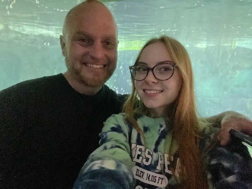 mitchell with daughter in front of aquarium mitchell with daughter in front of aquarium