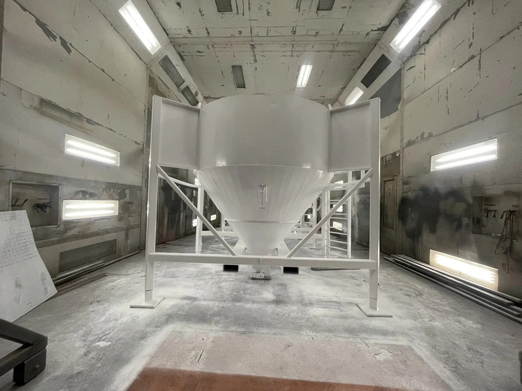 large vessel with fresh white coating in paint booth on our site Fresh, white coating prepared in our paint booth.
