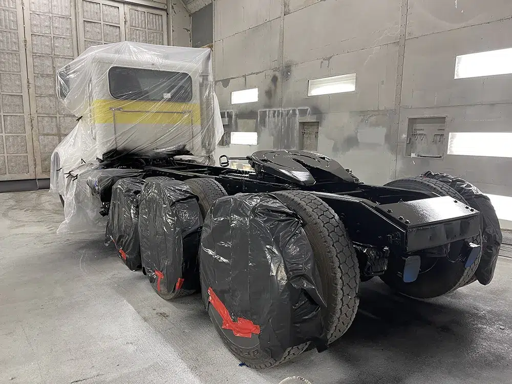 truck rig after blasting and coating in paint booth at fixed base location