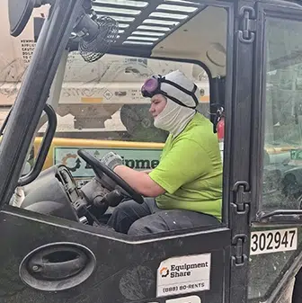 kenny feature photo of him driving a forklift