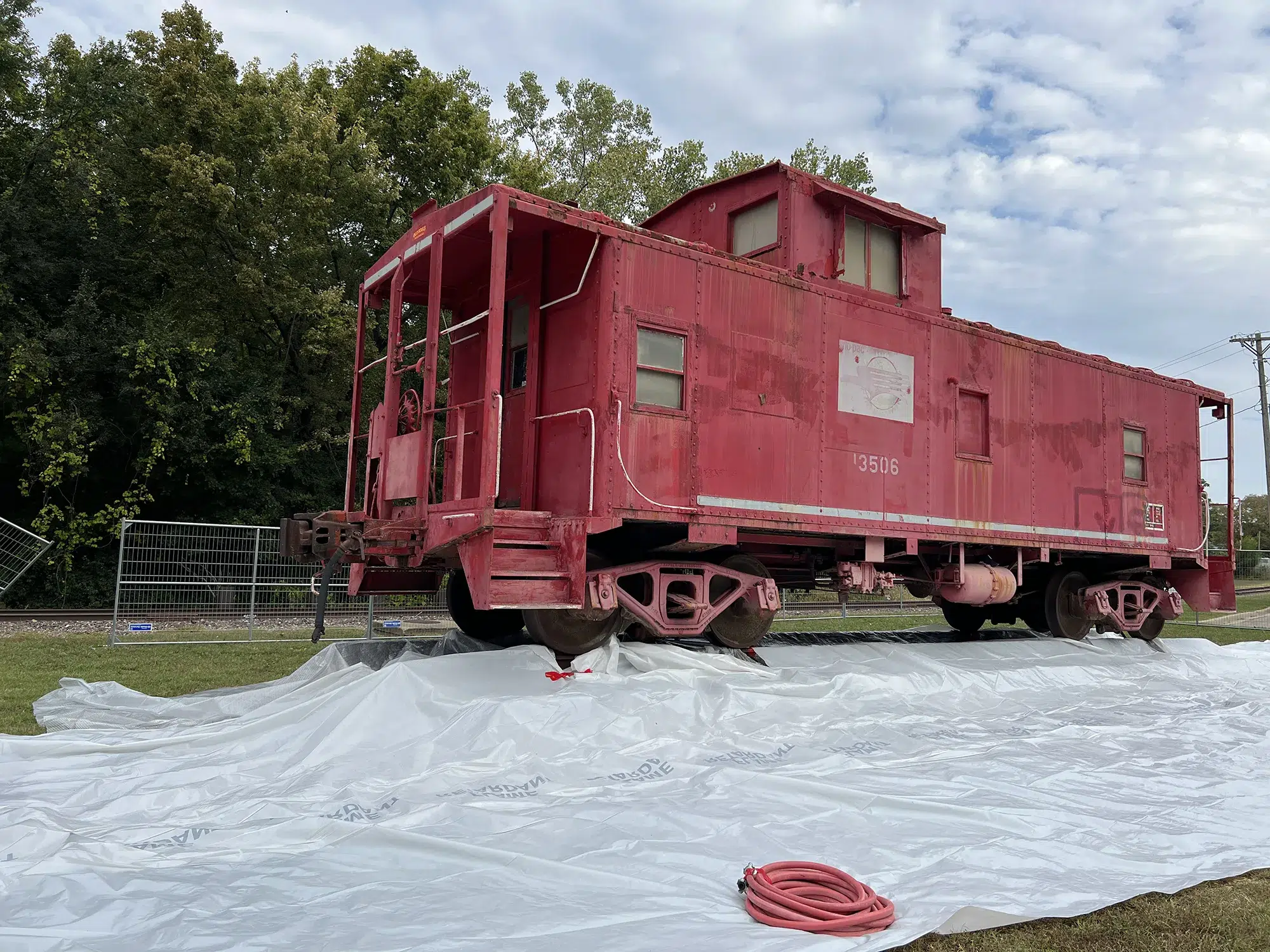 Railroad caboose being prepped for paint removal.