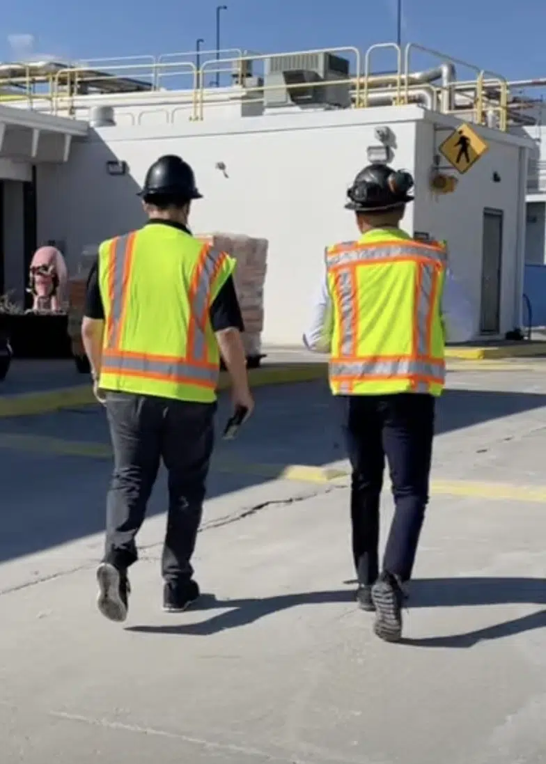 two men in ppe walking