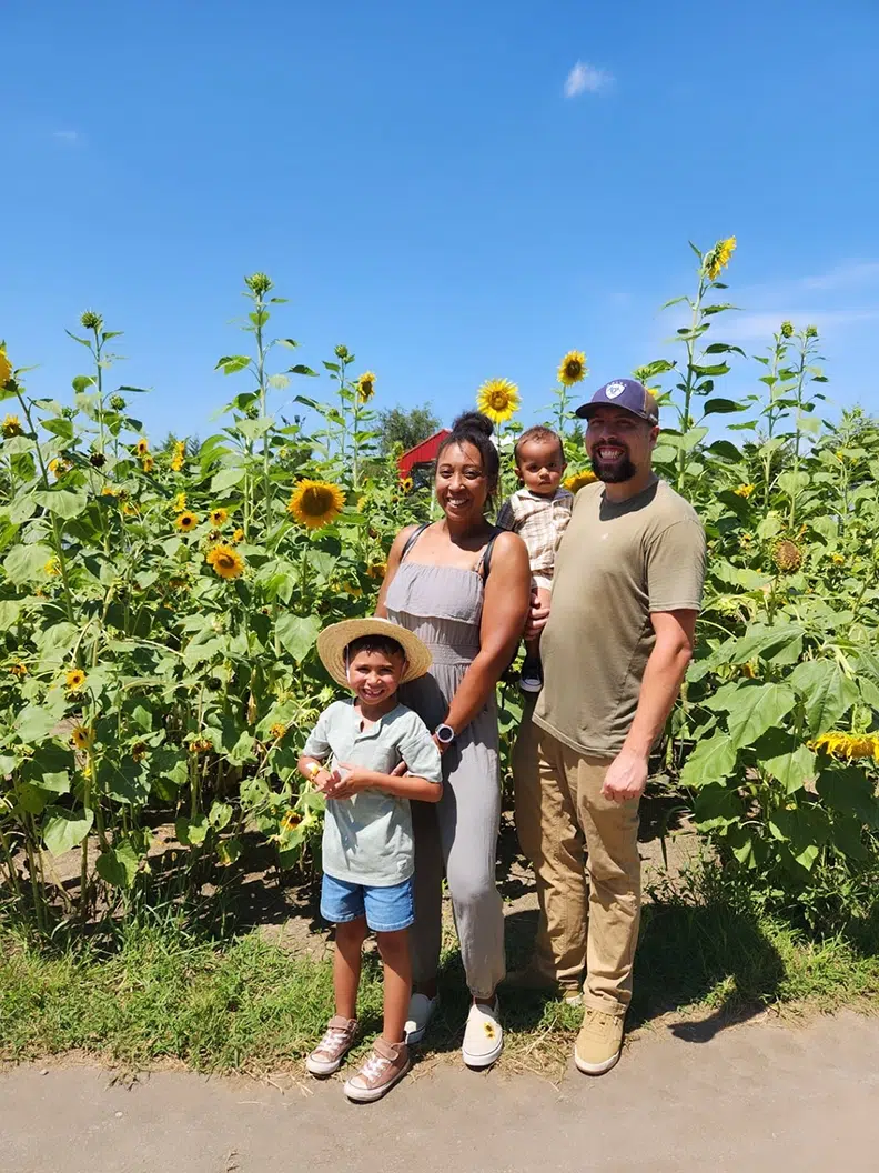 michael with family in front of sunflower field