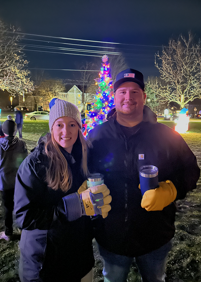 alex and wife in front of christmas tree