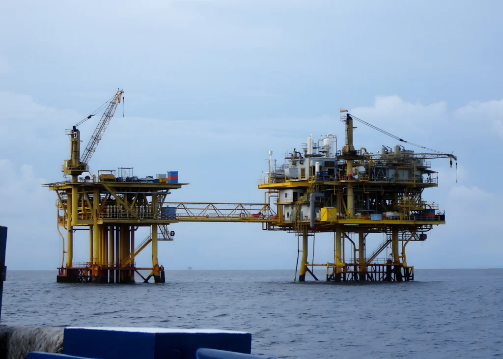 The perspective of a remote offshore oil and gas platform from a boat of offshore marine equipment service