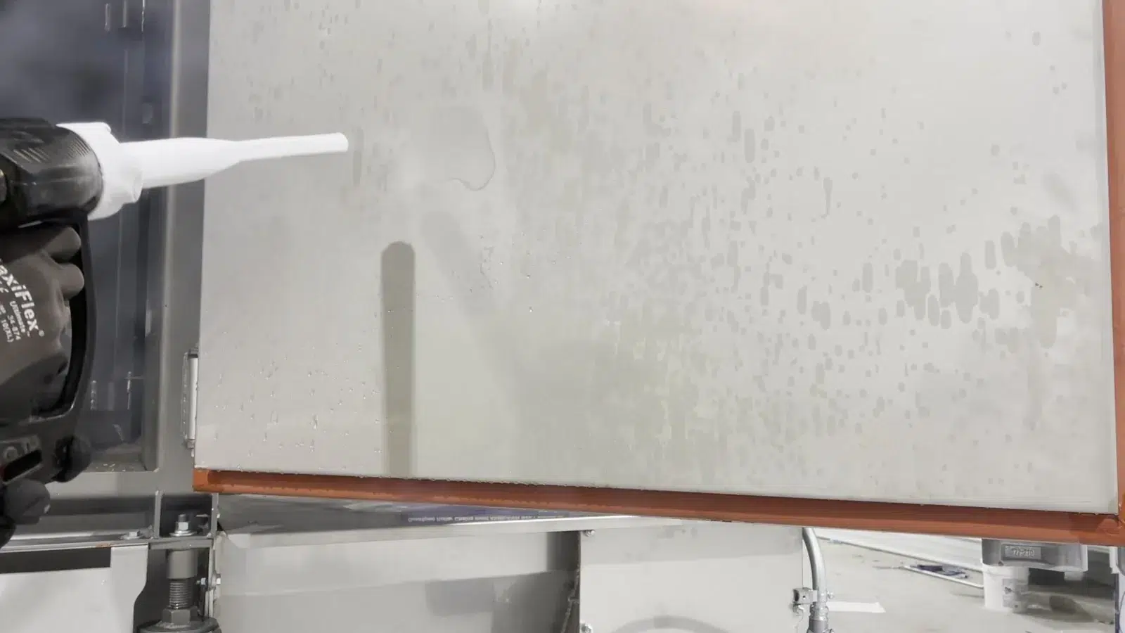 Dry ice blasting nozzle cleaning residue from an industrial equipment surface