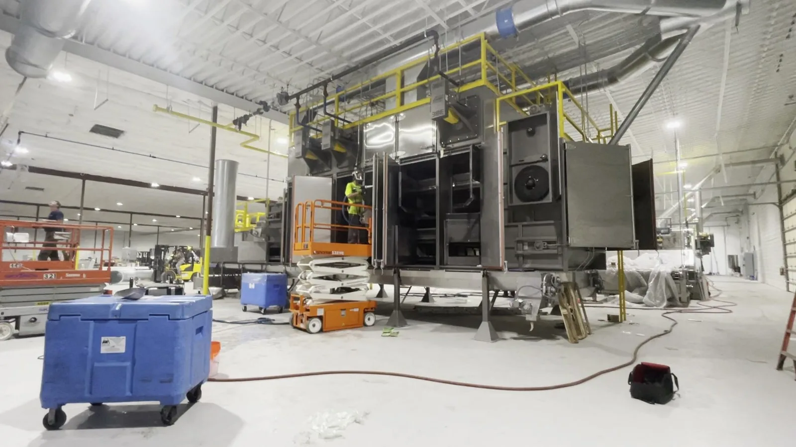 Large industrial manufacturing equipment inside a production facility.