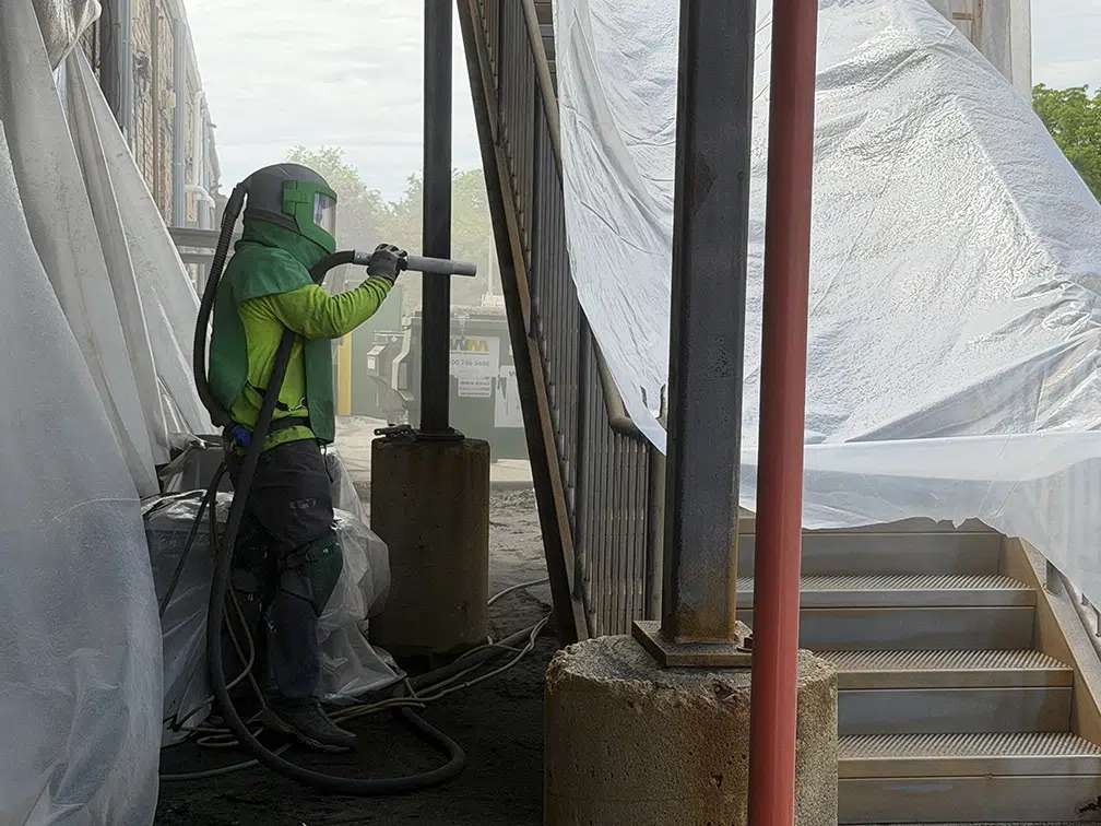 crew member blasting side of staircase