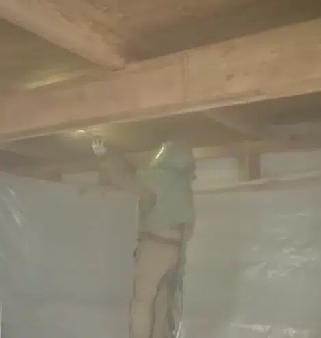 crew member walnut blasting interior of house